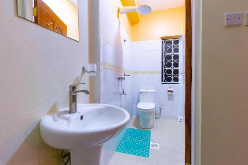 a bathroom with a sink and a toilet at Marrkson Suites Hotel in Nairobi