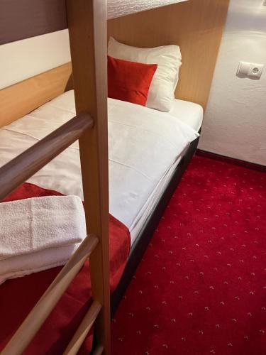 a bedroom with two bunk beds and a red carpet at Alpenzeit in Flachau