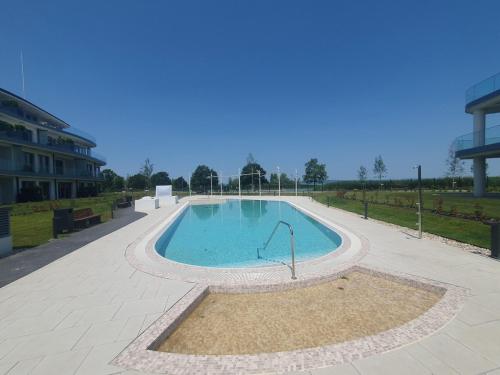 a swimming pool in the middle of a building at SzemesBay Apartment in Balatonszemes