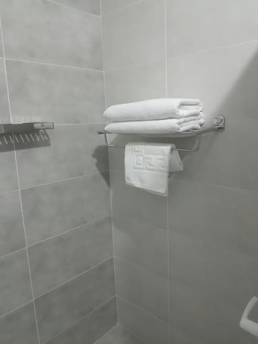 a bathroom with white towels on a towel rack at Marhaba Tausi Nyali in Mombasa