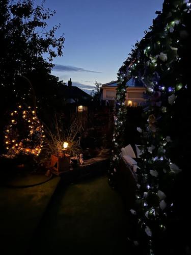 a garden at night with christmas lights in a yard at Romantic Swiss Cabin Hideaway & Hot Tub Spa Pool in Chandlers Ford