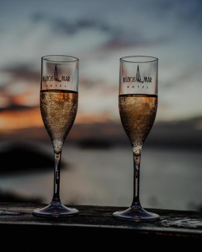 two glasses of champagne sitting on a table at Buzios Mar Hotel in Búzios