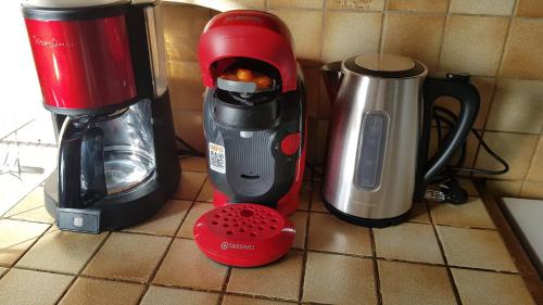 a kitchen counter with a blender and a coffee maker at Maison ouvrière pour 8 personnes in Trignac