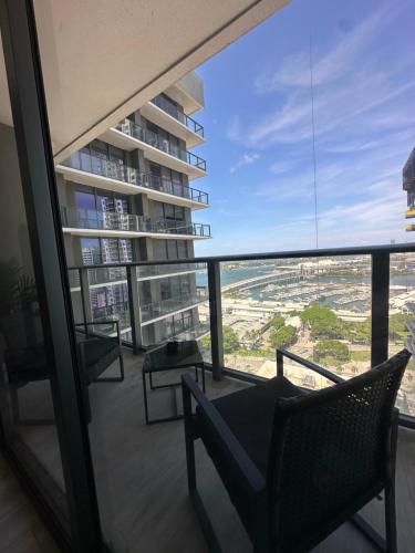 a view from the balcony of a building with a chair at Luxe Ventures Miami in Miami