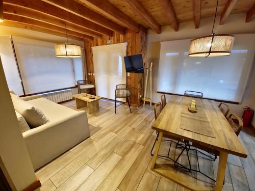 a living room with a couch and a table at Remanso del Bosque - Los Alerces Cabin in Villa La Angostura