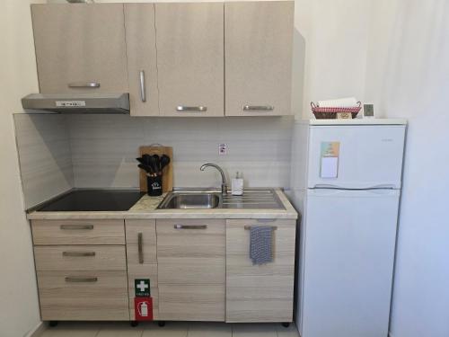 a small kitchen with a sink and a refrigerator at Bindi Studio Apartment in Draç