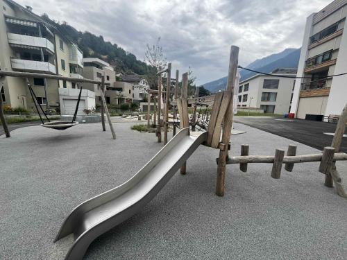 a playground with a slide in a park at Historische Maisonettewohnung bis 10 Gäste, Magic Pass Belalp, Rosswald und mehr in Naters