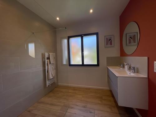 a bathroom with a sink and a window at Maison individuelle contemporaine avec piscine in Urrugne