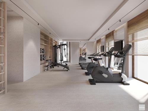 a gym with treadmills and elliptical machines at Hotel Molo Resort in Osiek