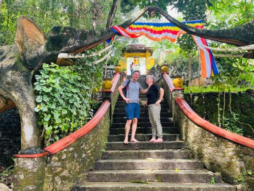 two people standing on the stairs at a temple at Ayuwaters Authentic Yoga and Ayurveda Retreat by the Bentota River All Inclusive in Bentota