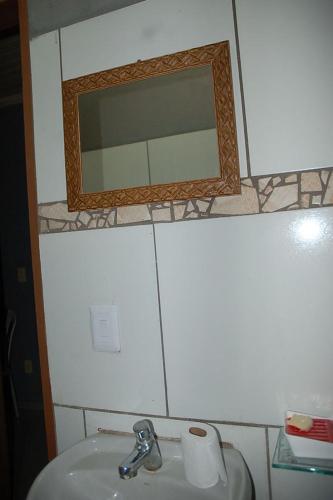 a bathroom with a sink and a mirror at Pousada Manua in Manaus