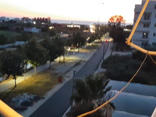 a view of a street with trees and a building at Sunrise Apartment Rruga Qeret Kavaje in Kavajë