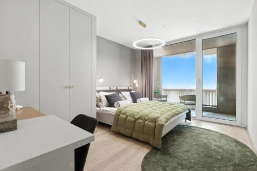 a white bedroom with a bed and a large window at Castle-side Luxury Residence on Danube River bank,Free Parking in Bratislava
