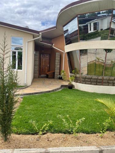 a house with a lawn in front of it at Infinity La Casa in Naivasha