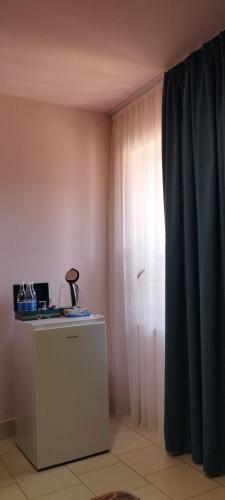 a corner of a room with a window and a desk at Aramyants Castle in Alaverdi