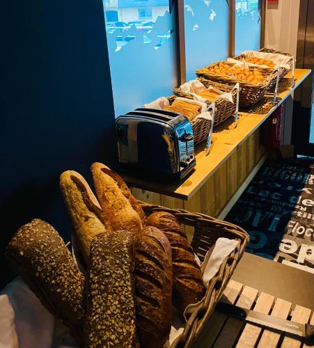 a pair of gloves sitting on a counter with bread at Hotel le Sacca, nouvelle équipe in Cauterets