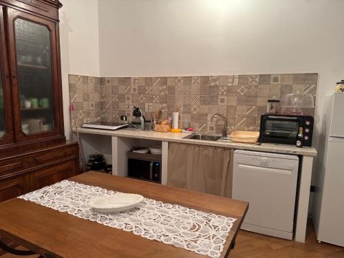 a kitchen with a table and a counter top at Casa Crevole in Palazzina