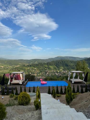 a resort with a swimming pool and a view at Sky Space Slavske Котеджі в горах з теплим басейном in Slavske
