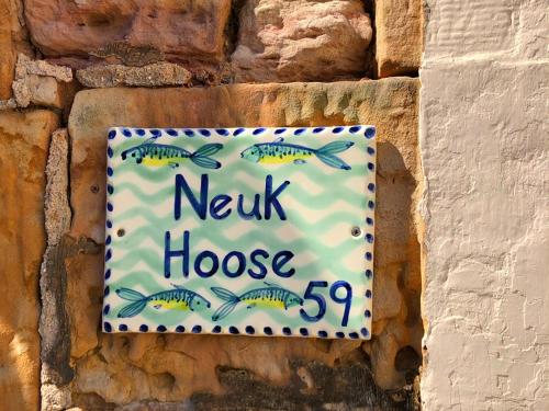 a sign for a new house with fish on it at Neuk Hoose in Crail