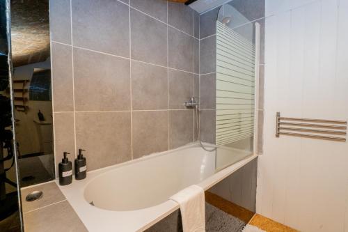 a bathroom with a bath tub in a room at Artist Loft Experience Stylish 4-Bedroom Stay in Montreuil