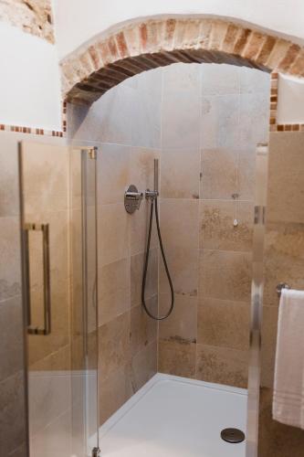a shower with a glass door in a bathroom at Borgo delle Fonti in Acquaviva Collecroce