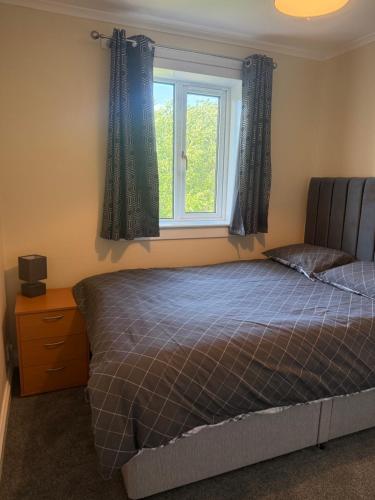 a bedroom with a bed and a window at 3 bedroom home Kirkcaldy in Fife