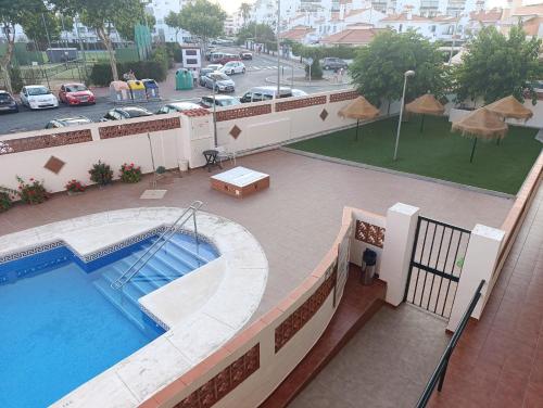 an overhead view of a swimming pool on a building at Apartamento en el Portil in El Portil