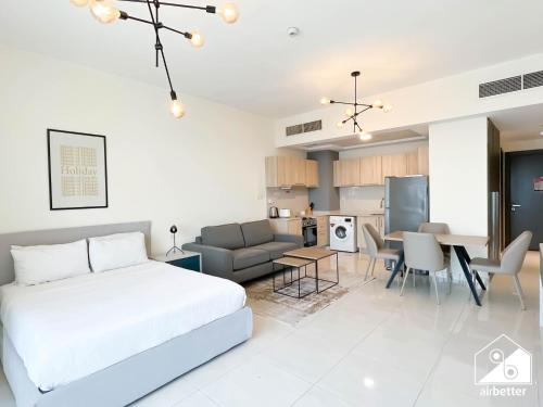 a bedroom with a bed and a living room at City-View Studio in AG Tower l Pool & Gym Access in Dubai