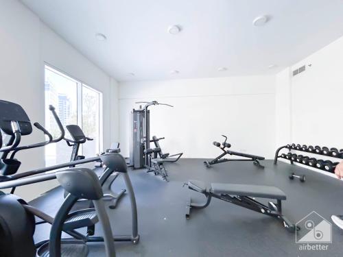a gym with several treadmills and exercise bikes at City-View Studio in AG Tower l Pool & Gym Access in Dubai