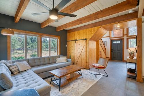 a living room with a couch and a table at Juniper & Pine, a Lodge-Style Cabin in Sisters, OR in Sisters