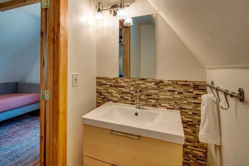 a bathroom with a sink and a mirror at Juniper & Pine, a Lodge-Style Cabin in Sisters, OR in Sisters