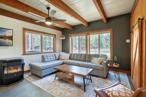 a living room with a couch and a fireplace at Juniper & Pine, a Lodge-Style Cabin in Sisters, OR in Sisters