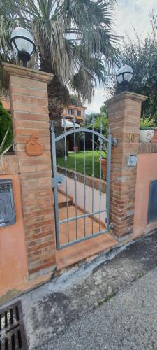 a wooden fence with a gate in front of a yard at Casa vacanze Levata del sole in Porto Potenza Picena