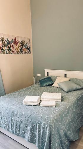 a bedroom with a bed with towels on it at Civico 18 Guest House in Cuneo