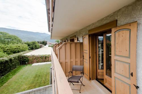 a balcony with a chair and a view at La Ferme Du Lac in Thyez