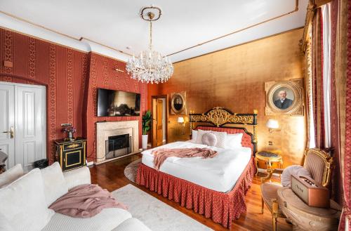 a bedroom with a large bed and a chandelier at Nosticova Heritage in Prague