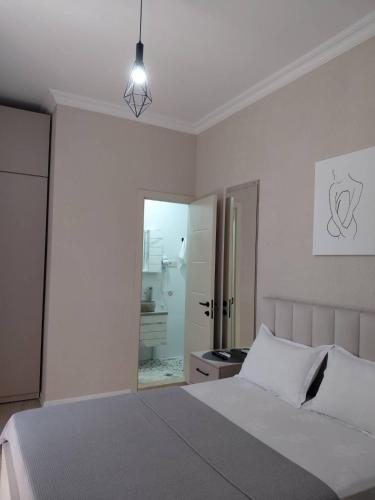 a bedroom with a bed and a door to a bathroom at Guest House NIMA in Kutaisi