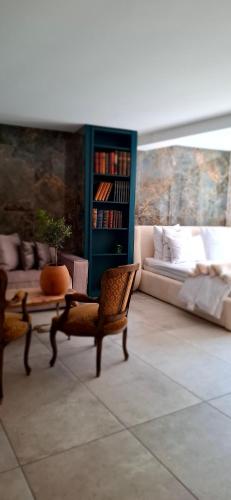 a living room with a couch and a table and chairs at La Suite Quatre de Saint Jean in Crémieu