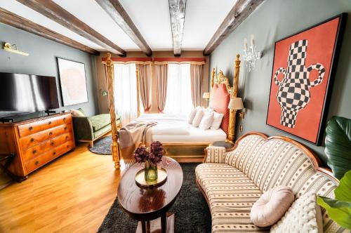 a living room with a bed and a couch at Nosticova Heritage in Prague