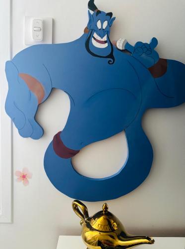a large superhero sign on a wall next to a teapot at THE ENCHANTED HOUSE ( 15 min walk to Disney) in Serris