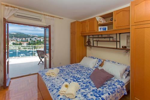 a bedroom with a bed with towels on it at SeaView Guesthouse in Hvar