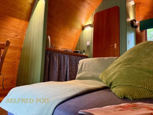 a bedroom with a bed with an unfinished roof at West Stow Pods in Bury St Edmunds in West Stow
