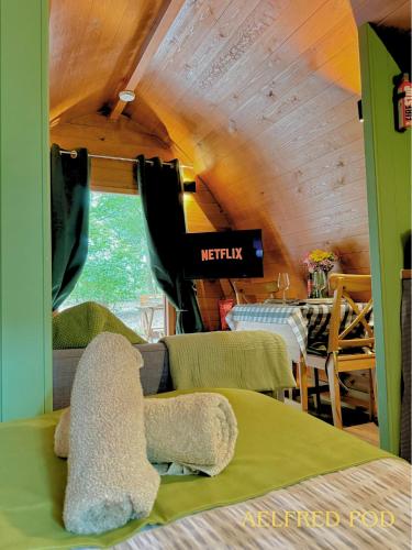 a teddy bear sitting on a bed in a room at West Stow Pods in Bury St Edmunds in West Stow