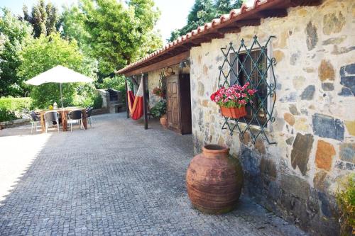 a building with a large vase sitting next to a patio at Quinta da Boa Ventura in Bragança