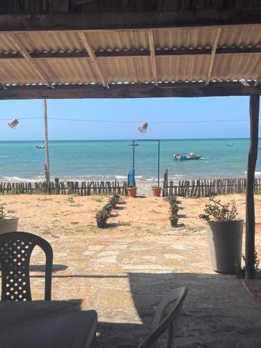 a view of a beach with a boat in the water at Pousada Quinta das Flores in Icapuí