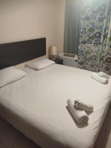a bedroom with a bed with towels on it at Evridiki in Vergina