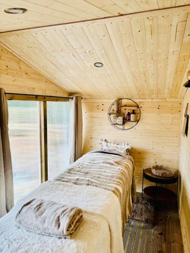 a bedroom with a bed in a wooden room at East Bridgford Summerhouse Inc Spa and Treatments in East Bridgford