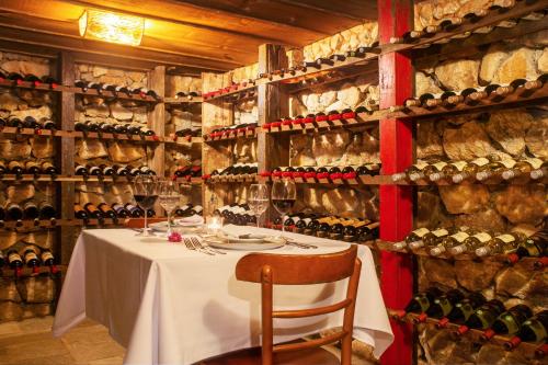 a dining room with a table and a wall of wine bottles at Parador Lumiar Boutique Hotel & Spa in Lumiar
