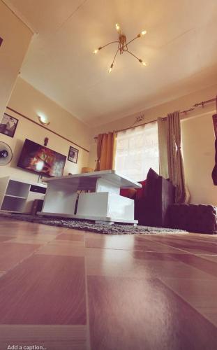 a living room with a bed and a window at Bay Loft Apartment 1 BR Netflix n Internet in Homa Bay