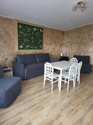 a living room with a couch and a table and chairs at Casa Ratiu 3 Stele Airport Bucharest Therme Bucharest in Baloteşti